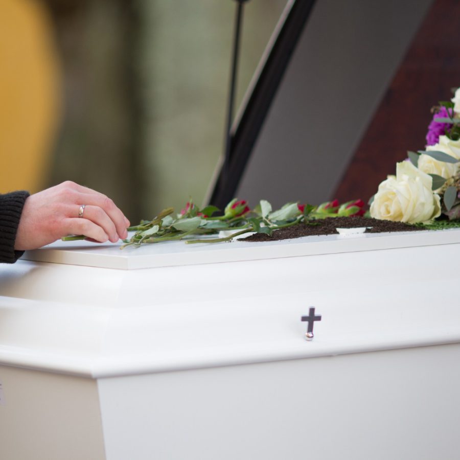 closeup-shot-person-hand-casket-with-blurred-background (2)